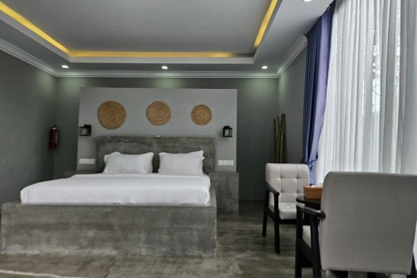 Bed view with chill out area at family villa - Damnak borey resort kampot
