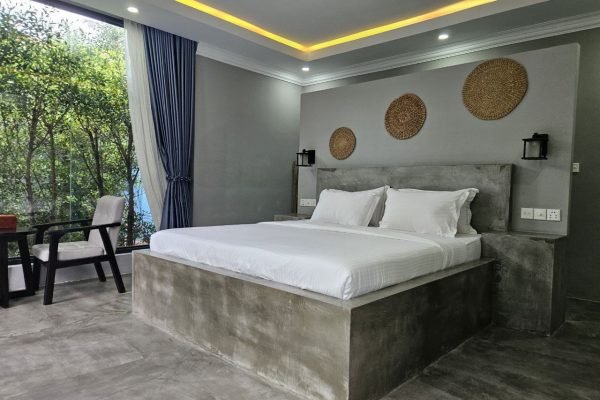 Side Bed view with chill out area at family villa - Damnak borey resort kampot